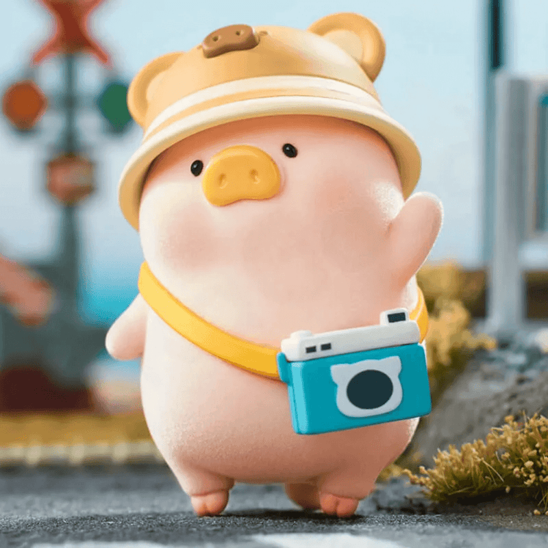 LuLu the Piggy's Travel Series Blind Box pig figure wearing a bear hat and carrying a blue camera