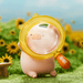 Lulu the Piggy's Travel Series Blind Box Explore figure holding a yellow magnifying glass in a sunflower scene