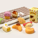 Malang Mozzi Bake Shop dessert mochi squishies styled on a desk with keyboard and blind box
