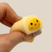 Hand squeezing a Malang Mozzi Bake Shop mochi squishy to show soft texture