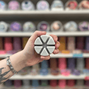 Mandarin and Sandalwood grey segmented wax melt held in hand