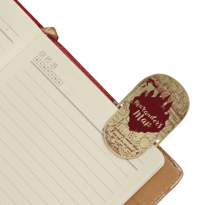 Harry Potter Marauder’s Map metal bookmark placed inside an open notebook
