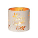 Round white and gold Merry Christmas tealight candle holder shown glowing