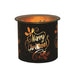 Black and gold Merry Christmas tealight wax melter glowing with warm light
