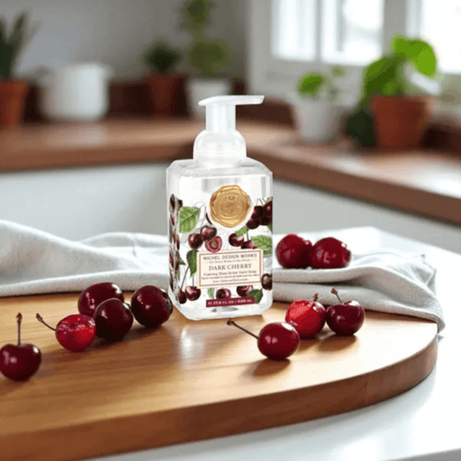 Michel Design Works Dark Cherry foaming hand soap 530ml on a wooden board with fresh cherries