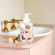 Michel Design Works Pressed Flowers foaming hand soap 530ml on bathroom counter beside sink with flowers
