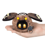 Front view of the Micro Squishable Death's-head Hawkmoth plush keychain with fuzzy brown body and golden eyes
