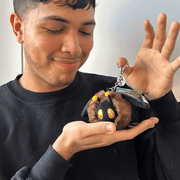Micro Squishable Death's-head Hawkmoth plush keychain being held for size comparison