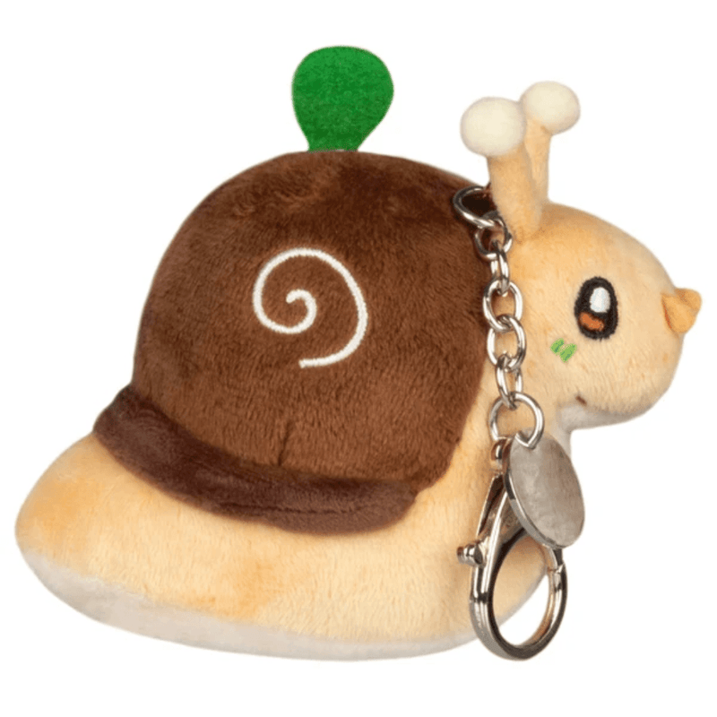 Side view of Micro Squishable Garden Snail plush keychain showing embroidered brown spiral shell and metal keyring