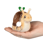 Micro Squishable Garden Snail keyring resting on a hand with metal clip and green sprout