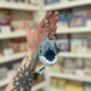 Front view of Micro Squishable Megalodon Keychain showing its shark face, open mouth and soft blue plush design