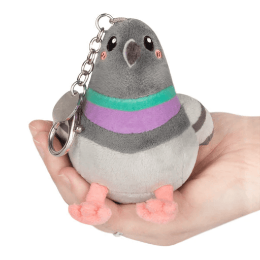 Front view of the Micro Squishable Pigeon plush keychain with grey body, pink feet and metal clip