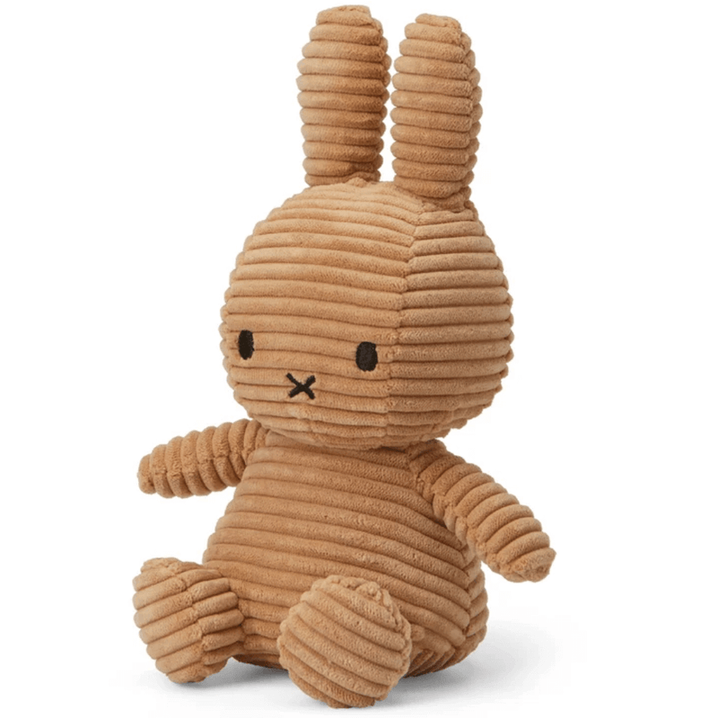 Angled side view of beige corduroy Miffy plush soft toy, 23 cm, showing ribbed texture.