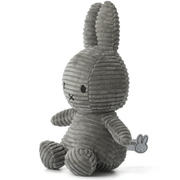 Angled side view of grey corduroy Miffy plush rabbit, 23 cm, showing ribbed texture.