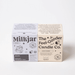 Milkjar Aurora candle box next to The Feel-Good Candle Co box on a white background.