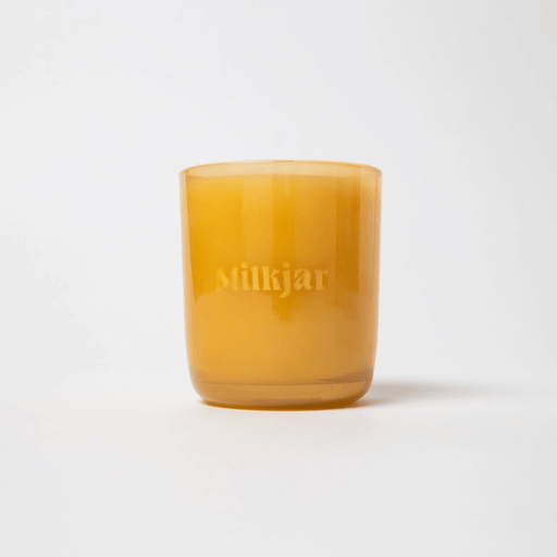 Milkjar Before Sunrise candle in an amber glass jar on a white background