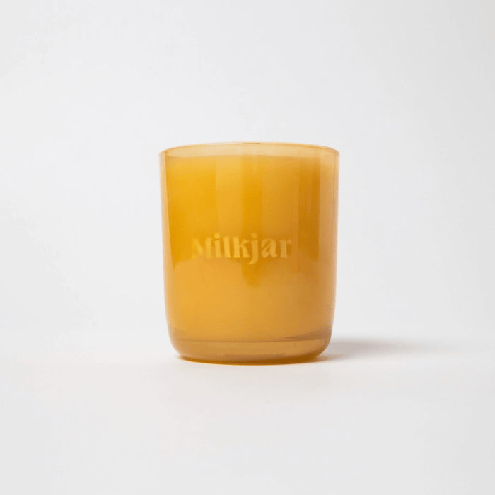 Milkjar Before Sunrise candle in an amber glass jar on a white background
