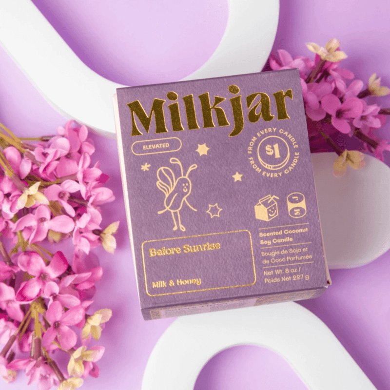 Close-up of Milkjar Before Sunrise Milk & Honey candle box with gold lettering