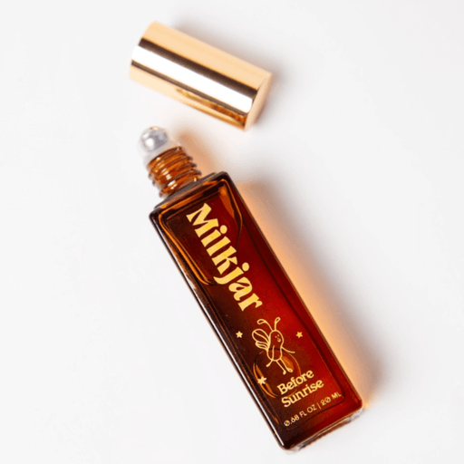 Open Milkjar Before Sunrise perfume roller showing rollerball applicator with lid beside bottle