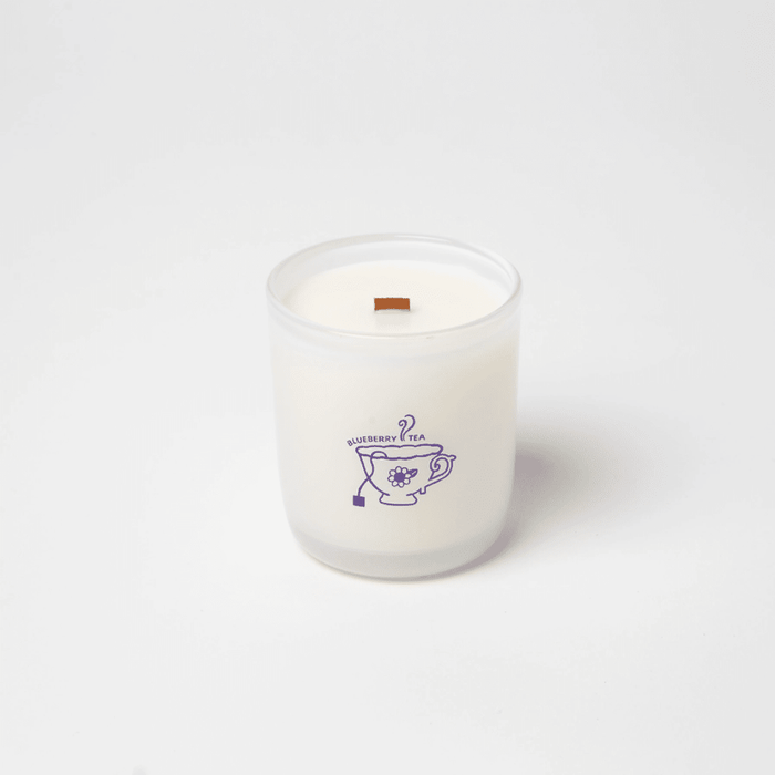 Milkjar Blueberry Tea coconut soy candle 8oz on a white background with Blueberry Tea label and wooden wick.