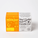 Milkjar Citrus candle box next to The Feel-Good Candle Co box on white background.