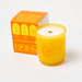 Milkjar Citrus candle beside box showing icons for wooden wick, essential oils and coconut soy wax.