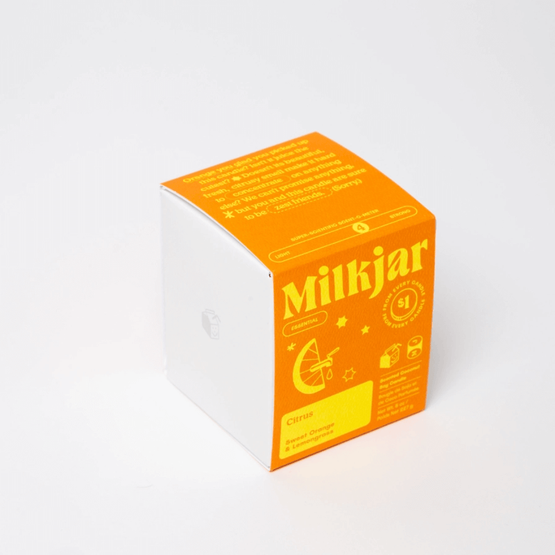 Milkjar Citrus candle box showing Sweet Orange and Lemongrass essential oil scent on white background.
