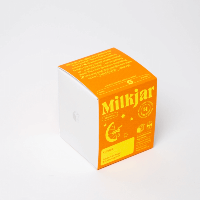Milkjar Citrus candle box showing Sweet Orange and Lemongrass essential oil scent on white background.