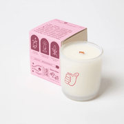 Milkjar Dandy coconut soy candle 8oz photographed at an angle on a white background with wooden wick and Dandy icon.