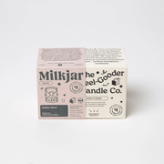 Milkjar Golden Hour candle box beside The Feel-Good Candle Co box on a white background.