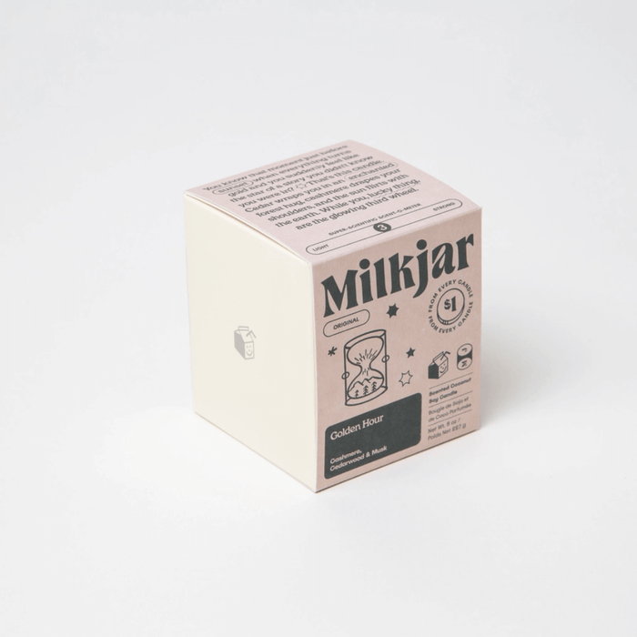 Angled view of Milkjar Golden Hour candle box showing Cashmere, Cedarwood and Musk scent.