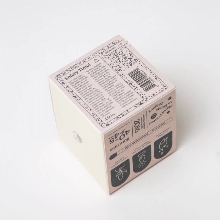 Top of Milkjar Golden Hour candle box showing safety label and barcode.