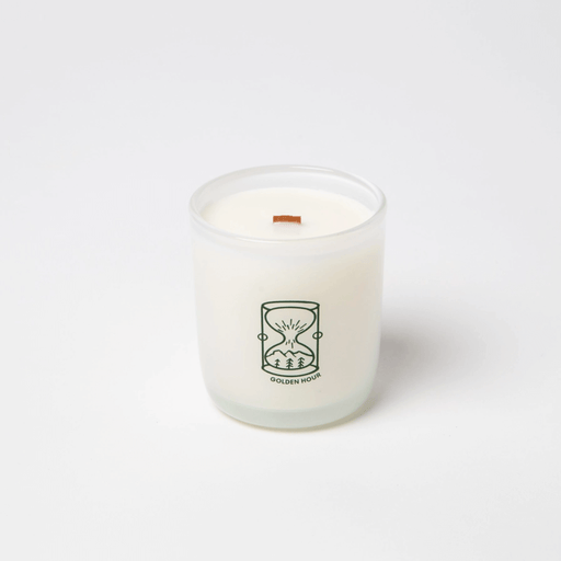 Milkjar Golden Hour coconut soy candle in frosted glass with wooden wick on a white background.