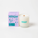 Milkjar Hawaii Plumeria and Lilac coconut soy candle with matching box on a white background.
