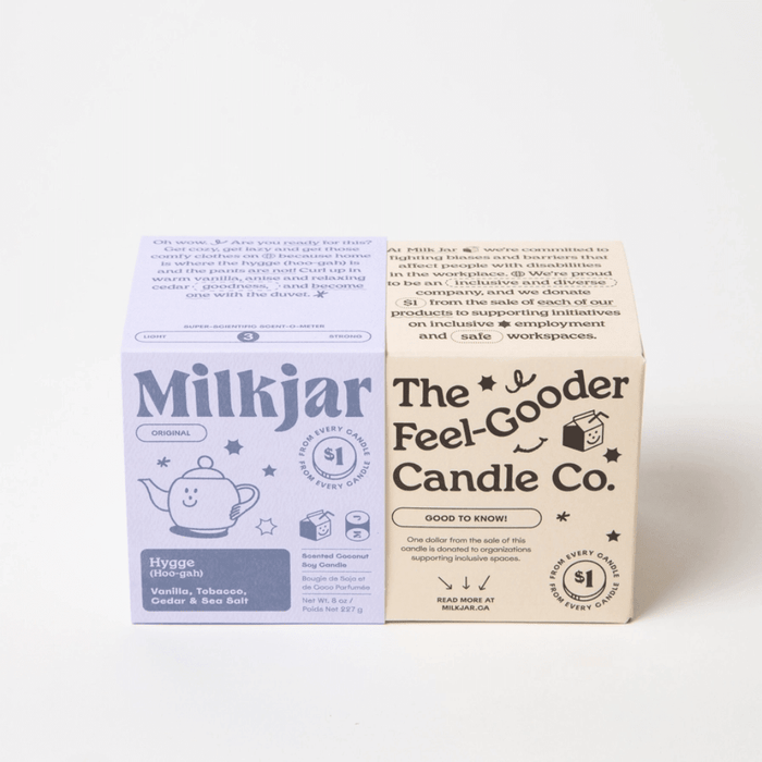 Milkjar Hygge candle box beside The Feel-Gooder Candle Co. packaging on a white background.