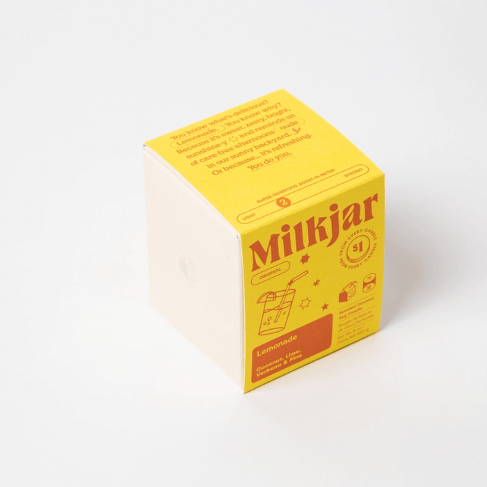 Back of The Feel-Good Candle Co box with inclusive workplace message and $1 donation information.