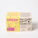 Milkjar Sunnyside candle box next to The Feel-Good Candle Co box on a white background.