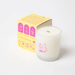 Angled view of Milkjar Sunnyside candle box showing White Nectarine and Pear scent on a white background.