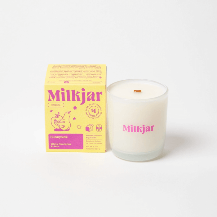 Milkjar Sunnyside white nectarine and pear candle with matching box on a white background.