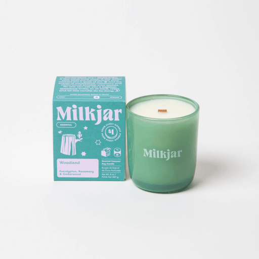 Milkjar Woodland essential oil coconut soy candle 8oz shown with the product box on a clean white background.
