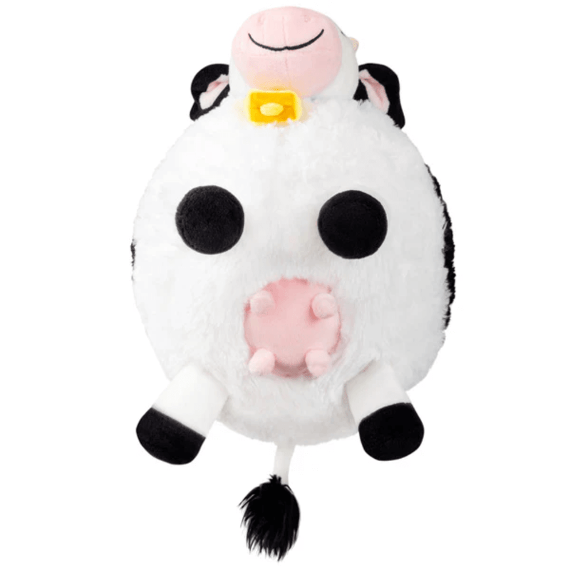 Underside view of Squishable Mini Cow plush toy showing legs and pink udder detail