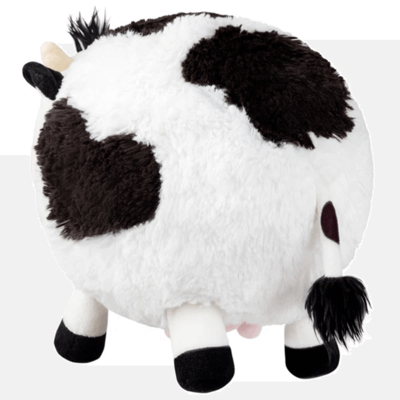 Back view of Squishable Mini Cow plush toy showing black and white fur and tail