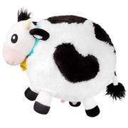 Side view of Squishable Mini Cow plush toy showing black patches and fluffy tail