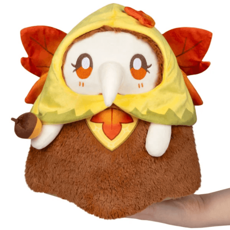 Mini Squishable Autumn Fairy Plague Nurse plush with yellow leaf hood, orange eyes and cream beak