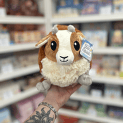 Mini Squishable Baby Goat plush toy held in hand, front view showing the sweet goat face, soft brown and cream plush fur, tiny grey horns and fluffy chest
