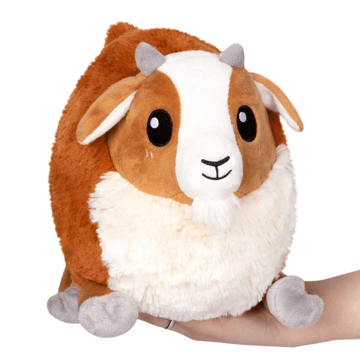 Front view of Mini Squishable Baby Goat plush toy with brown fur, white face and small grey horns.
