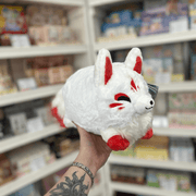 Mini Squishable Baby Kitsune fox plush toy with soft white fur, red-tipped tail, red paws and embroidered face