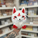 Mini Squishable Baby Kitsune plush toy with white fluffy fur, red markings, pointed ears and cute fox face