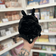 Back view of Mini Squishable Baby Mothman plush toy showing its soft black fluffy body and small moth details