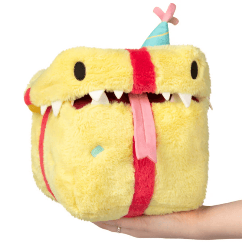 Front view of the Mini Squishable Birthday Mimic Gift plush toy with teeth, tongue and party hat
